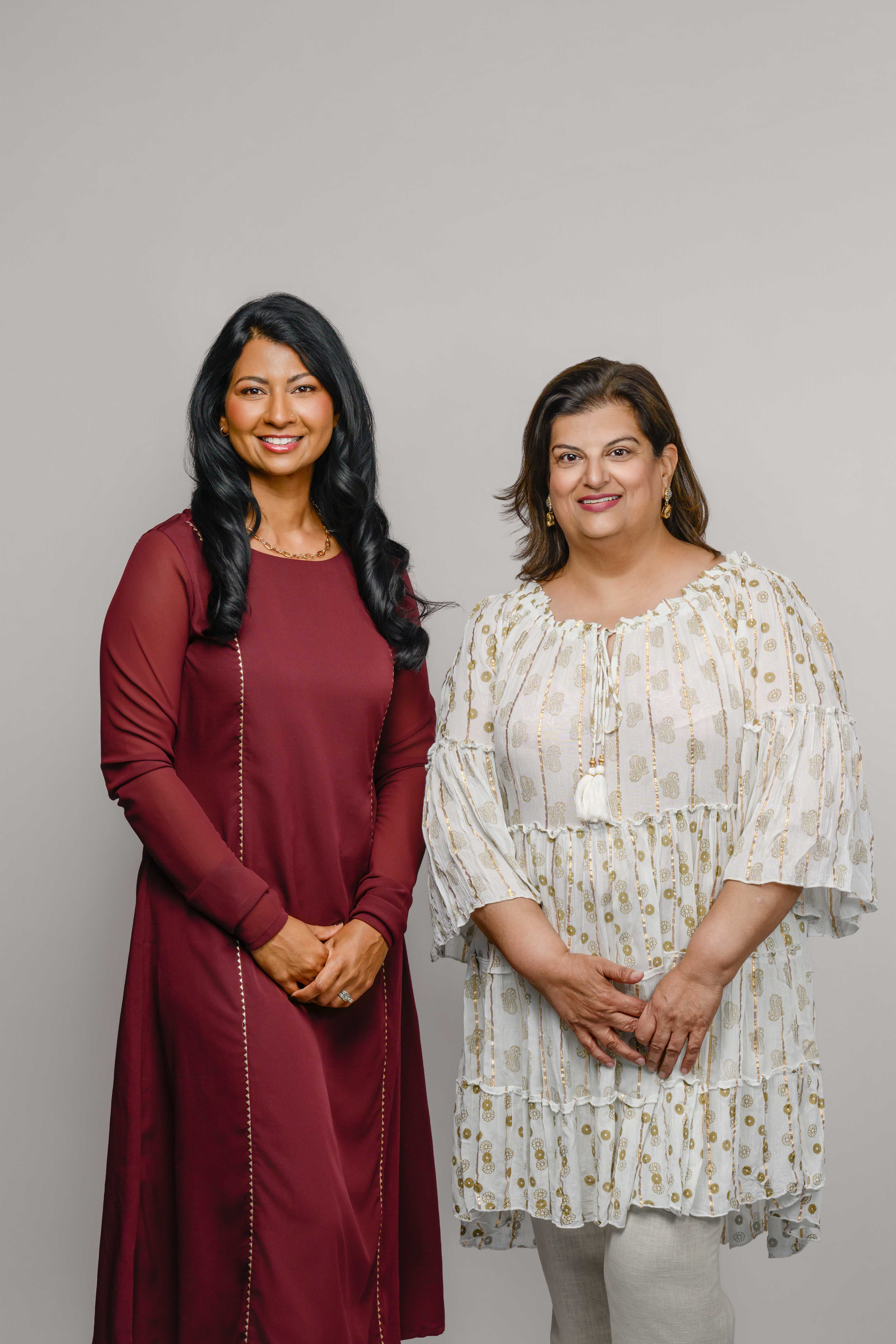 The two founders of Saath Wellness standing together in a warm studio portrait