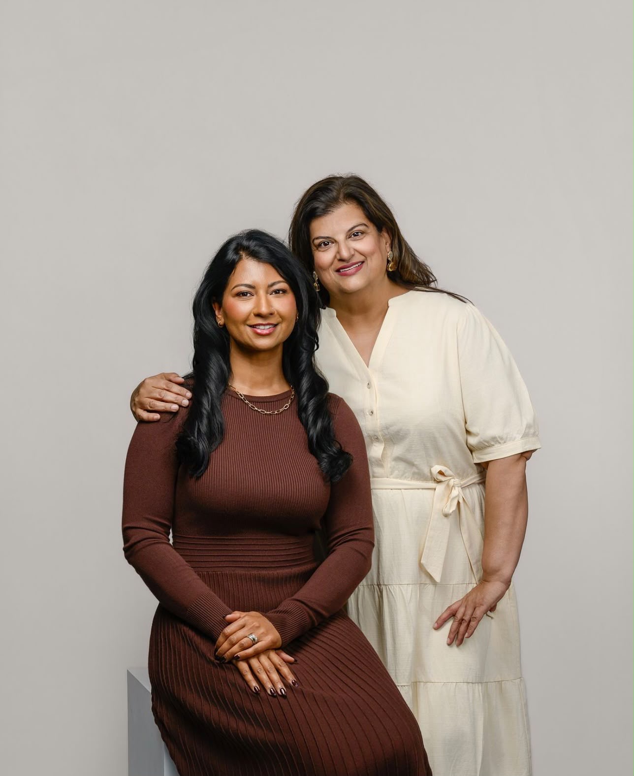 Nav and Sim, the founders of Saath Wellness, standing together in a studio portrait